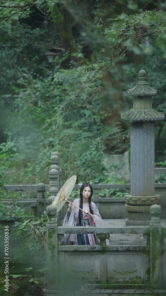 female in costume holds umbrella in garden female in costume holds umbrella in garden
