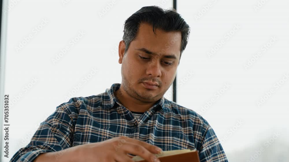 Indian student is preparing for the exam, reading book Indian student is preparing for the exam, reading book
