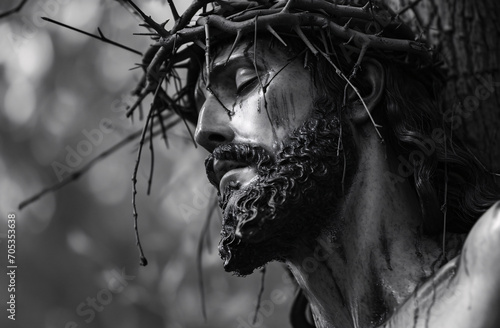 statue of Jesus Christ with crown of thorns on the cross photo