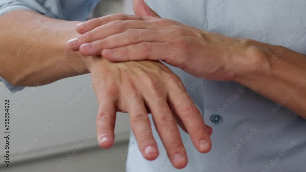 Young man smearing a white moisturizer on his hands close-up. Morning routine. Beauty and care concept. Young man smearing a white moisturizer on his hands close-up. Morning routine. Beauty and care concept.
