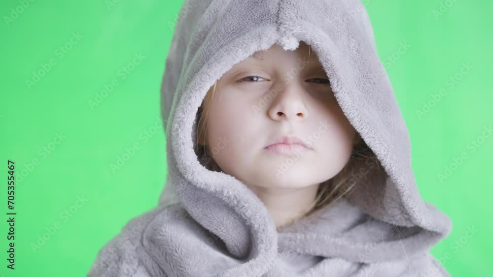 Serious look of the little girl with hood on her head Serious look of the little girl with hood on her head