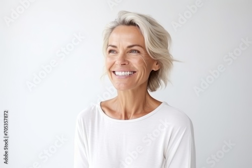 Portrait of a happy mature woman with short blond hair smiling at the camera photo