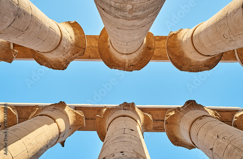 Majestic columns with ancient Egyptian drawings, sun comes out from behind the column. luxor Temple in Luxor, Egypt