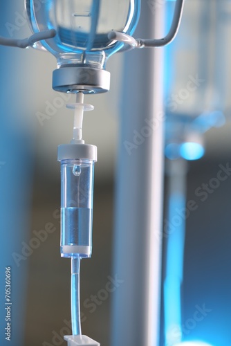 IV drip chamber against blurred light background