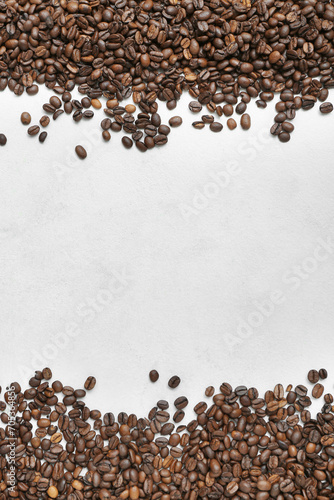 Frame made of coffee beans on light background