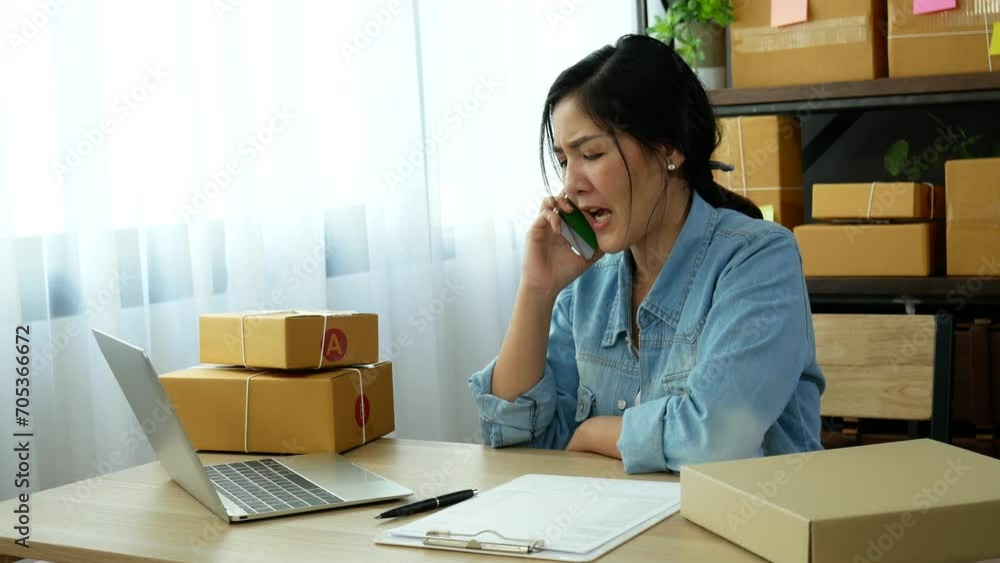 Online seller entrepreneur young asian woman using phone calling, checking online order. Woman calling check goods stock, delivery package shipping. Asian woman startup small business at home office Online seller entrepreneur young asian woman using phone calling, checking online order. Woman calling check goods stock, delivery package shipping. Asian woman startup small business at home office