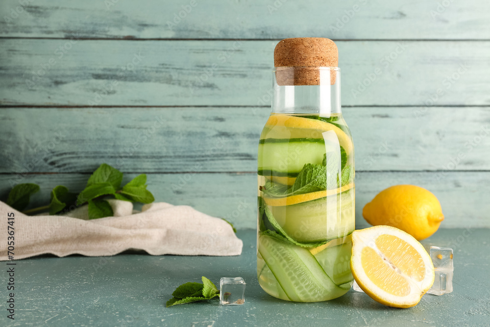 Bottle of lemonade with cucumber and mint on blue table - obrazy, fototapety, plakaty 