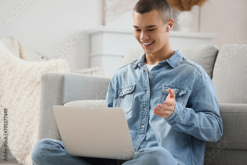 Young man with laptop video...