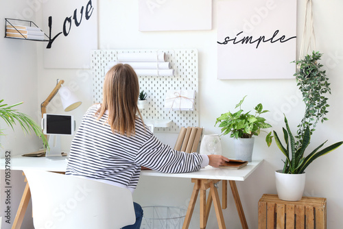 Young woman working at desk...