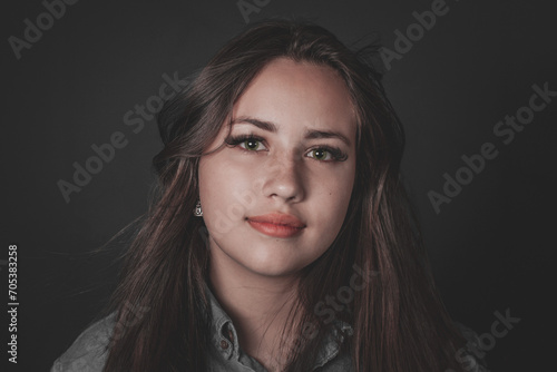 beautiful young woman with long hair and beautiful eyes looking straight ahead