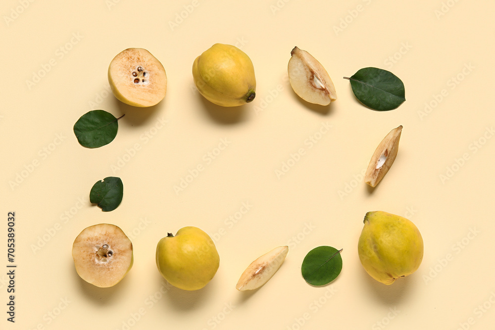 Frame made of sweet ripe quinces and leaves on yellow background Frame made of sweet ripe quinces and leaves on yellow background