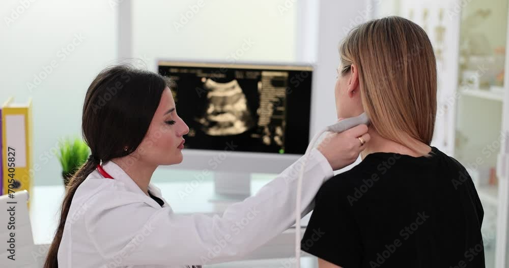Woman patient undergoing ultrasound scan of neck by doctor