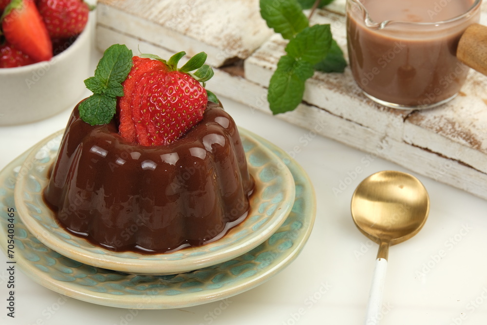 Chocolate pudding or puding coklat with strawberry,delicious sweet dessert on white background Chocolate pudding or puding coklat with strawberry,delicious sweet dessert on white background