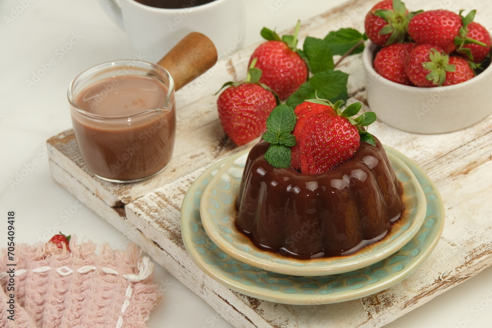 Chocolate pudding or puding coklat with strawberry,delicious sweet dessert on white background Chocolate pudding or puding coklat with strawberry,delicious sweet dessert on white background