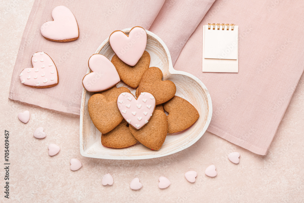 Plate with sweet heart shaped cookies on pink background Plate with sweet heart shaped cookies on pink background