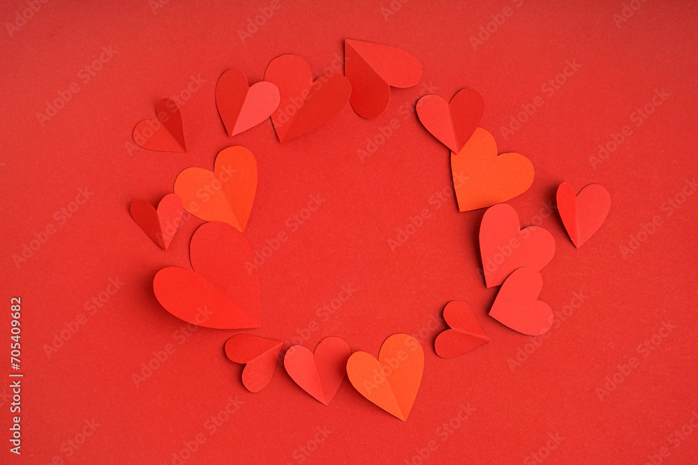 Frame made of paper hearts on red background. Valentine's Day celebration
