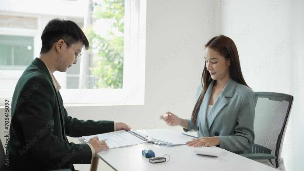 Automotive business Ideas for selling or leasing cars The customer and the car dealer make a contract and sign the contract. Document agreement in car sales office 4k Automotive business Ideas for selling or leasing cars The customer and the car dealer make a contract and sign the contract. Document agreement in car sales office 4k