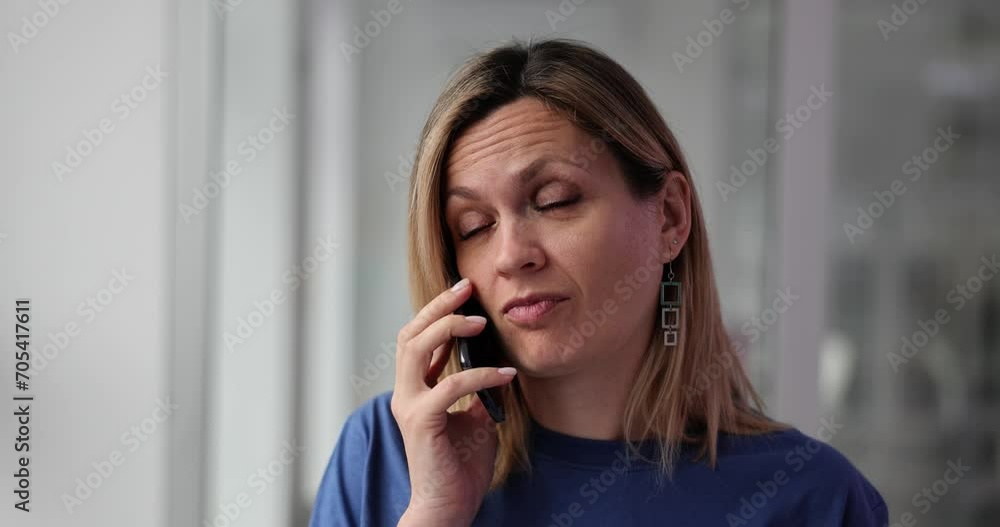 Confused, puzzled woman communicates with smartphone, looks questioningly and rolls eyes Confused, puzzled woman communicates with smartphone, looks questioningly and rolls eyes