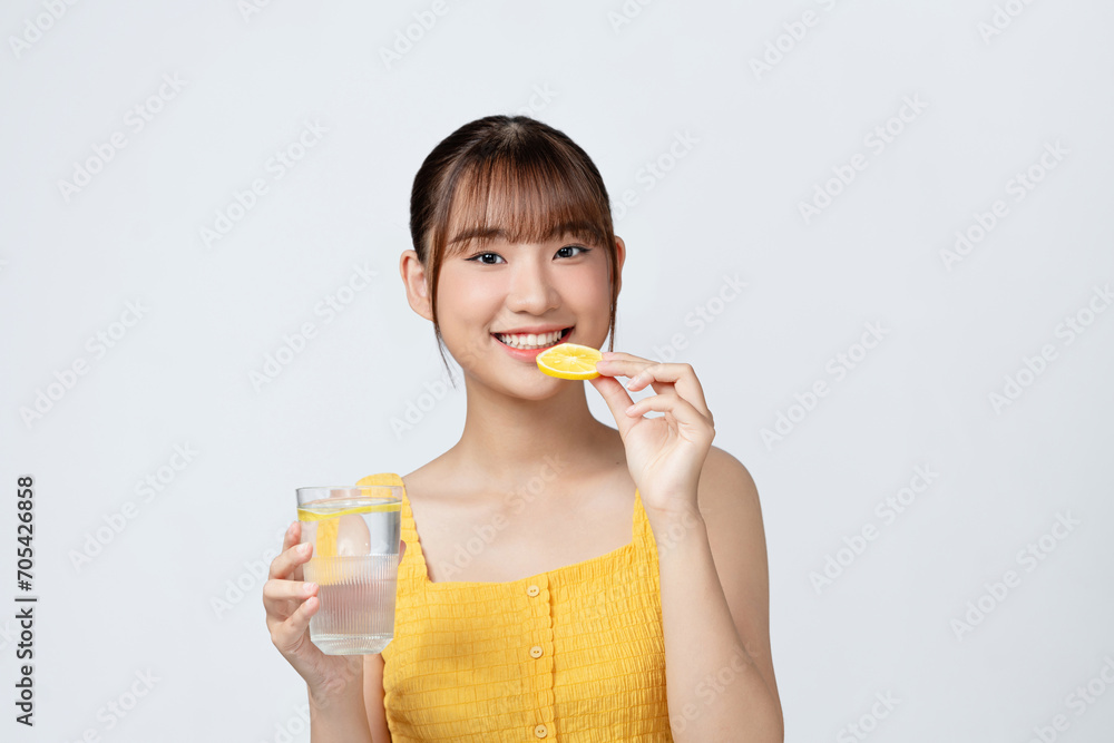 Young woman with glass of lemon water on white background Young woman with glass of lemon water on white background