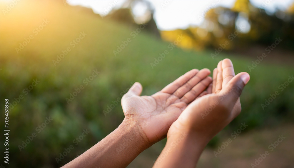 Hands in prayer, open in respect, against serene nature backdrop