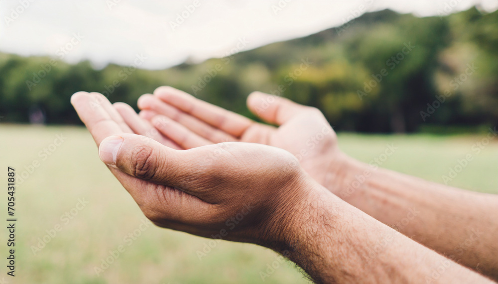Hands in prayer, open in respect, against serene nature backdrop Hands in prayer, open in respect, against serene nature backdrop