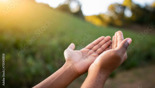 Hands in prayer, open in respect, against serene nature backdrop