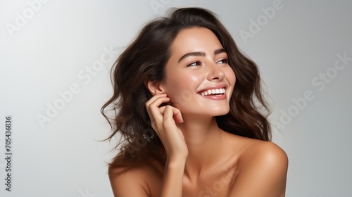 Portrait of a beautiful young woman with brown hair and white teeth smiling photo