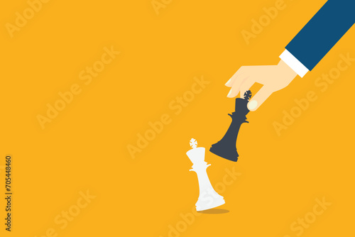 Hand holding black chess king and knocking down white one, checkmate. Business Strategy concept.