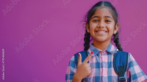 Indian school girl in unform isolated on pink photo