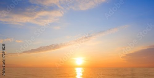 Fototapeta Naklejka Na Ścianę i Meble -  Majestic golden sunrise sky over sea with beautiful cloud and yellow sunlight reflection on water surface in the morning, Idyllic natural sunset seascape panoramic view background