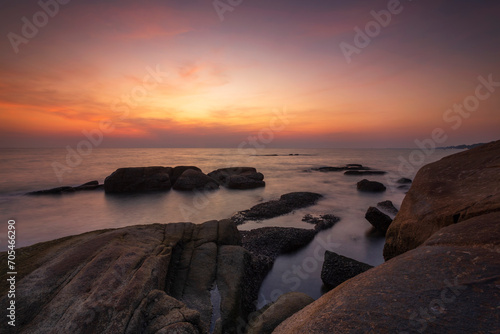 Beautiful scenery of sunset and rocks at Lan Hin Khao Beach in Rayong province, Thailand © isarescheewin