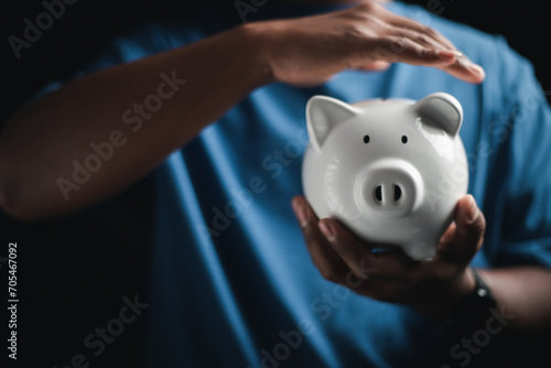 Happy businessman saving money on a piggy bank Saving ideas and money 