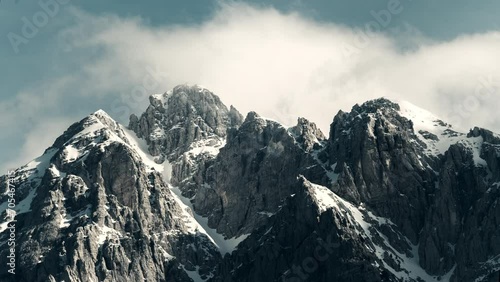 Timelapse of clouds over a dramatic snowy mountain range in Theth Albania photo