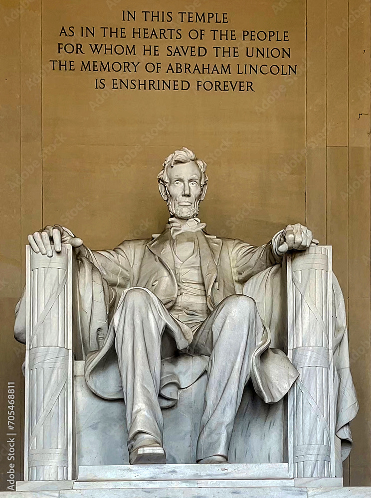 Vertical photo of the statue of Abraham Lincoln sitting on a chair at the National Mall Memorial in Washington DC (USA).