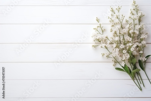 Background of plain white table and little flowers decoration © OGGYA