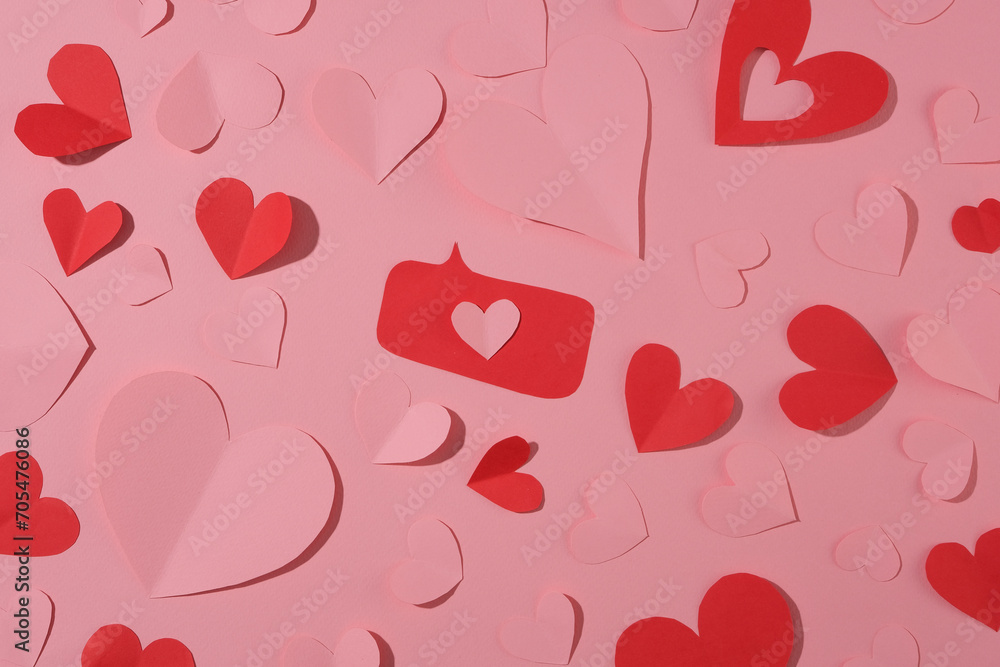 Pink abstract background with decorated pink and red hearts. Origami style paper craft. Love symbol for Valentine's Day