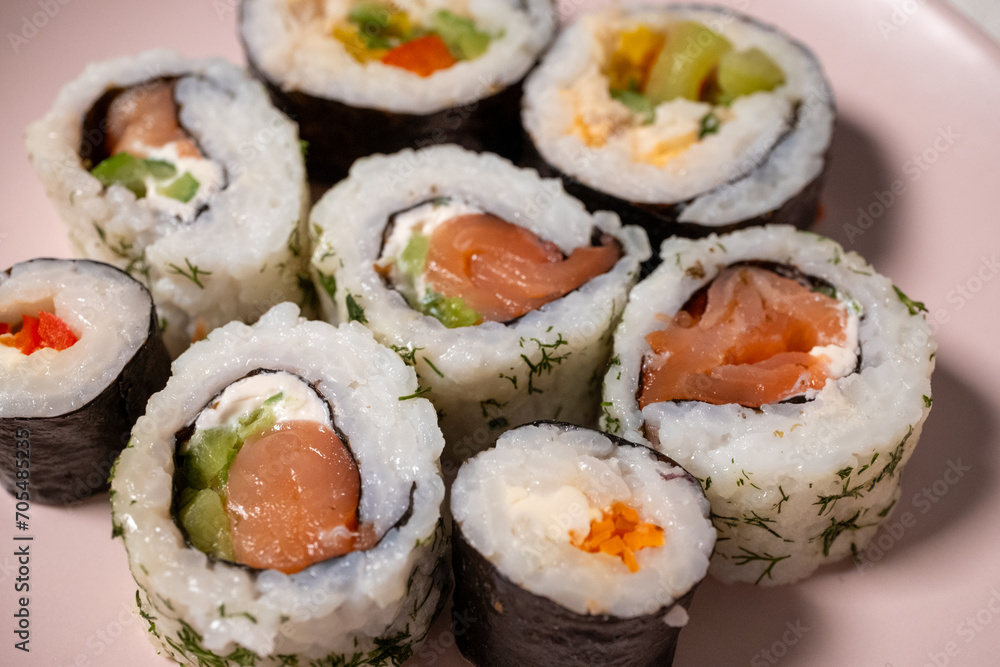 Chop sticks, mushrooms, noodle ramen, California rolls and Philadelphia rolls on a small plate on a pink background
Chop sticks, mushrooms, noodle ramen, California rolls and Philadelphia rolls on a small plate on a pink background