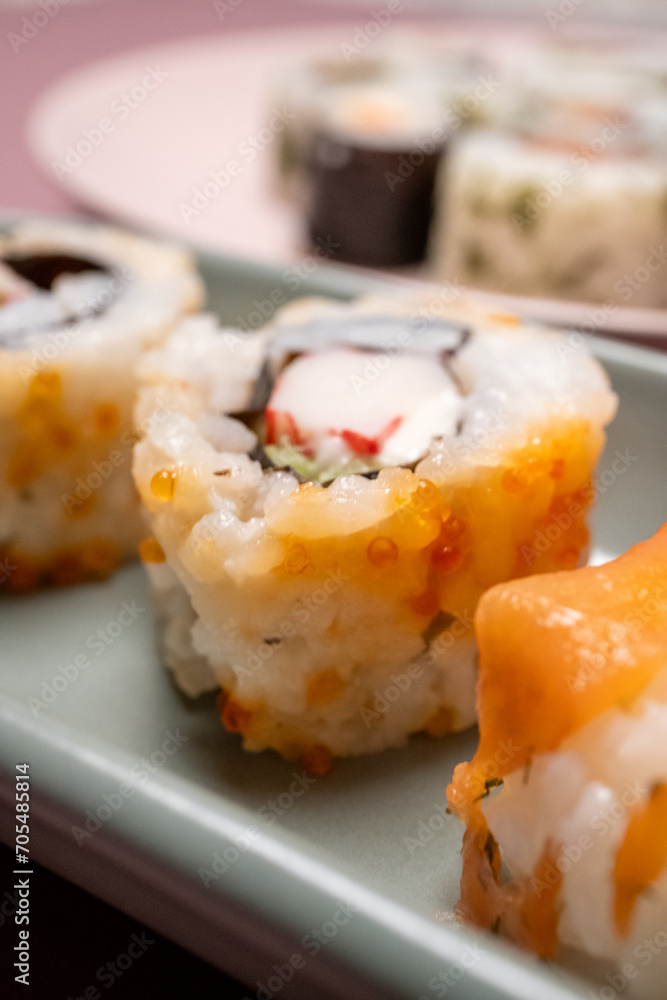 Chop sticks, mushrooms, noodle ramen, California rolls and Philadelphia rolls on a small plate on a pink background
Chop sticks, mushrooms, noodle ramen, California rolls and Philadelphia rolls on a small plate on a pink background
