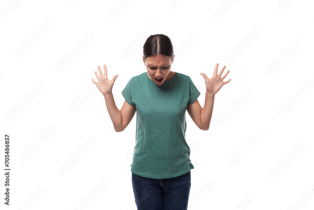 young slender woman dressed in a green basic t-shirt with a mockup looks confused young slender woman dressed in a green basic t-shirt with a mockup looks confused