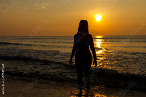 Woman body big with bikini and sunrise on beach