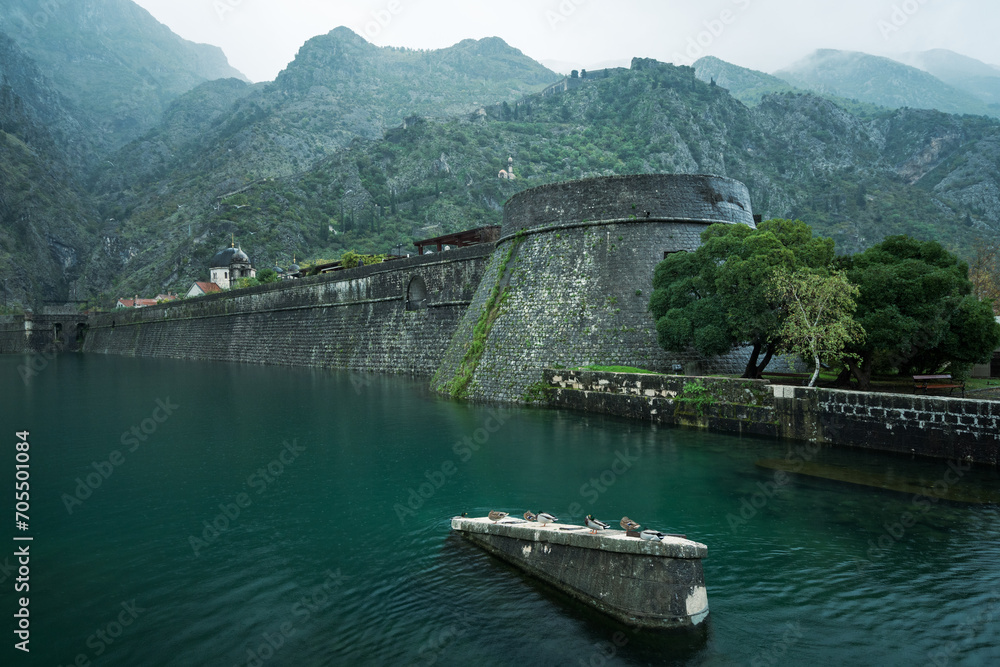 Fototapeta premium Kotor old city walls and surrounding mountains on a rainy day