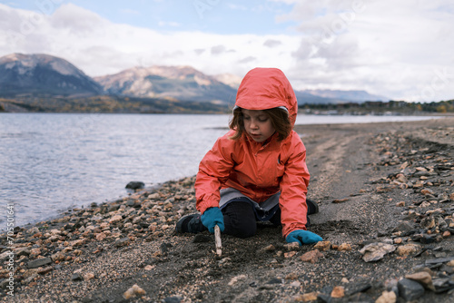 Young girl playing at the shore of Dillon reservoir