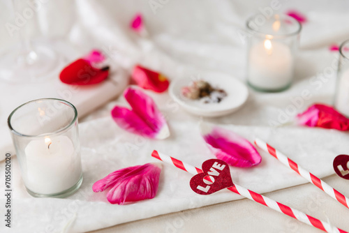 Fototapeta Naklejka Na Ścianę i Meble -  Valentine's Flatlay Cocktail, Candles and Flower Petals