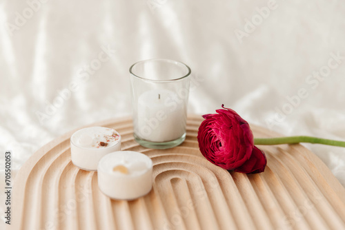 Nordic Style Wellness with Candles and a Ranunculus Stem photo