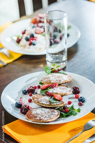pancakes with berries on plates