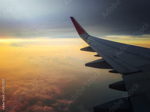 passenger jet airplane wing sunset orange sky