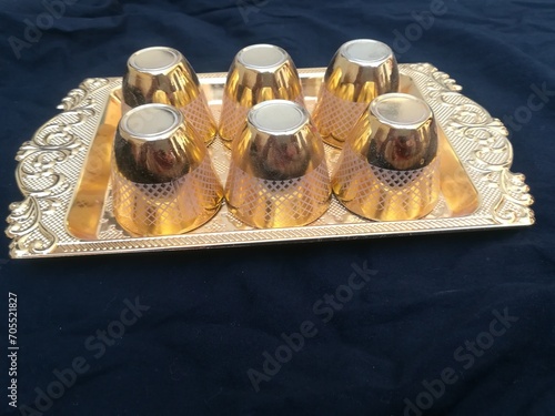 Small golden glasses in water