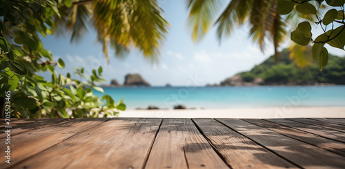 Empty wooden table with tropical beach theme in background photo