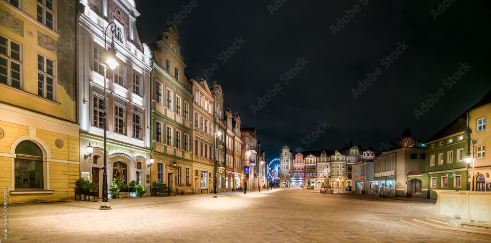 old market square in the center of a european city at night. Bright illumination. Urban tenement houses. Historic architecture