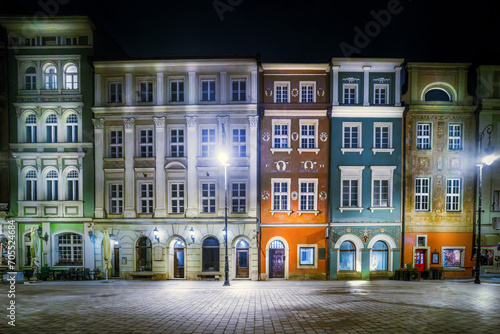 old market square in the center of a european city at night. Bright illumination. Urban tenement houses. Historic architecture